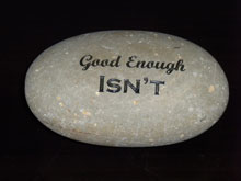 Good Enough Isn't engraved stone sign