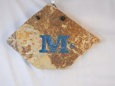 M's engraved stone sign