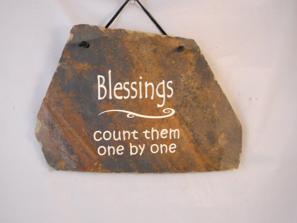 engraved stone sign with count your blessings on it