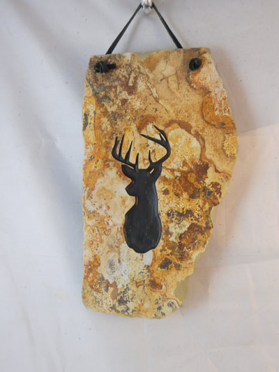 rock and slate sign with engraved deer head photo