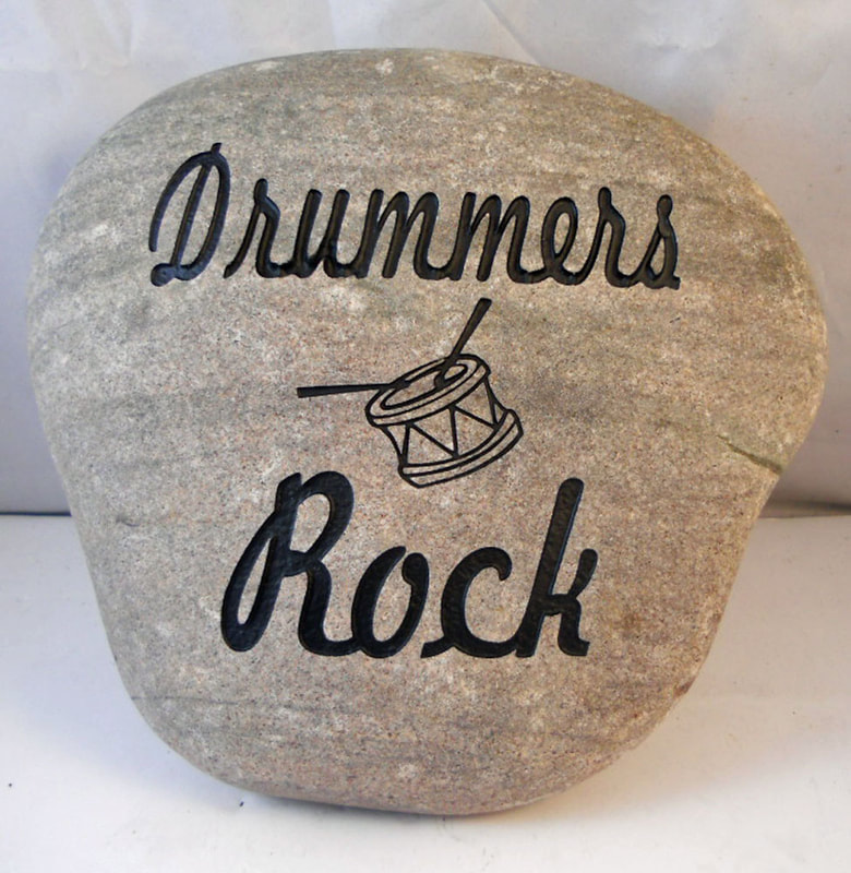 engraved rock with engrave letters "Drummers Rock"