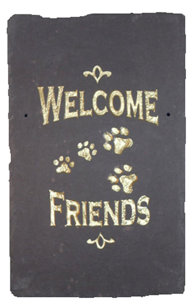 engraved rock sign with welcome friends and engraved paw prints