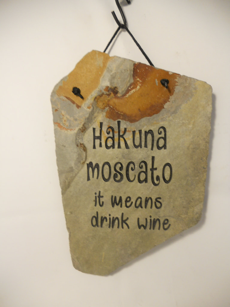 Hakuna Moscato it means drink wine 
funny engraved stone sign