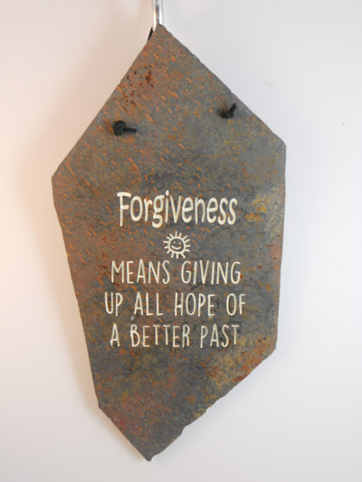 engraved rock sign and plaque about forgiveness