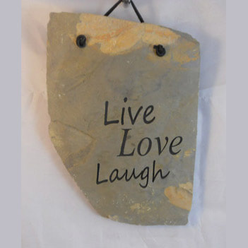 engraved rock sign and plaque that says live love laugh