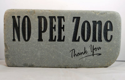 Engraved rock and paver no peeing sign